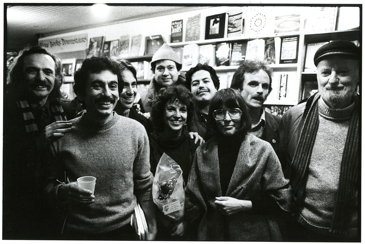 Group of authors, including Lawrence Ferlinghetti, smiling at the camera 