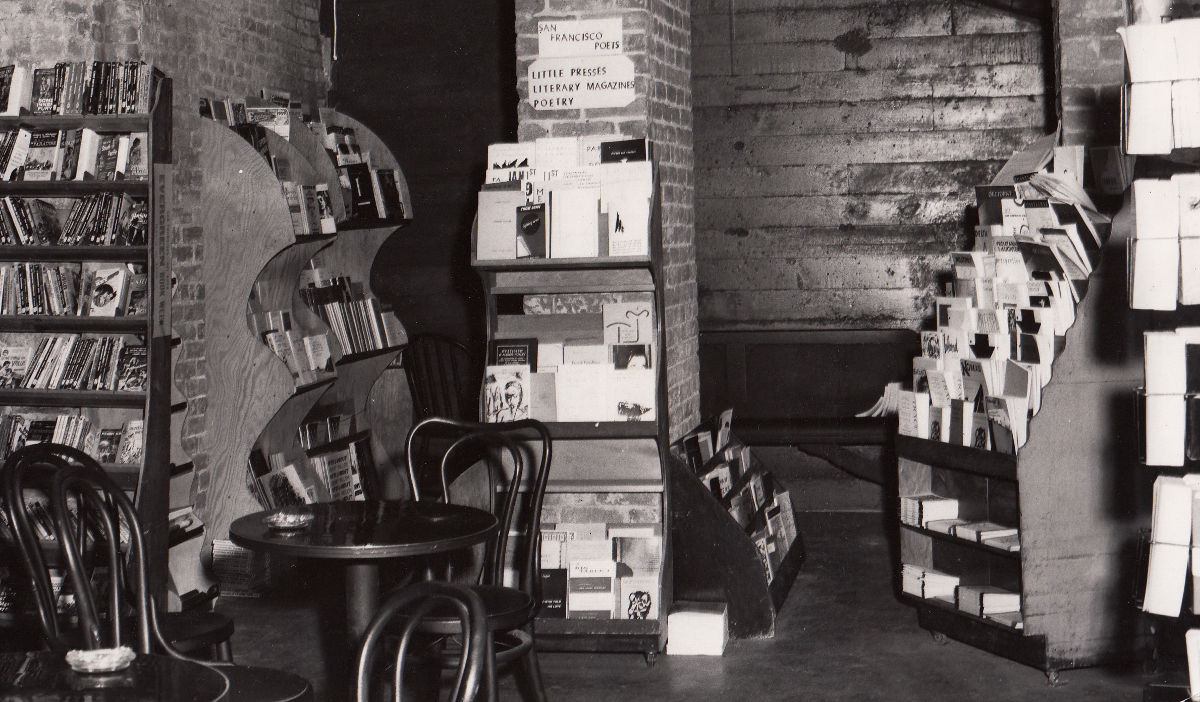 City Lights basement filled with bookshelves and a European-style cafe table 