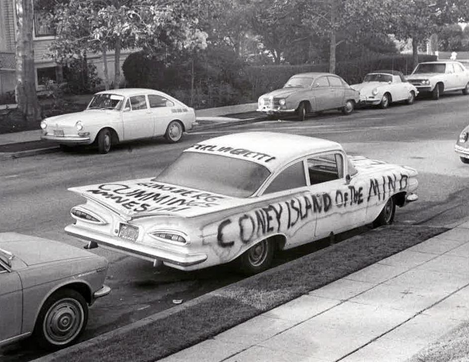 1950s car spray-painted with words CONEY ISLAND OF THE MIND on its side